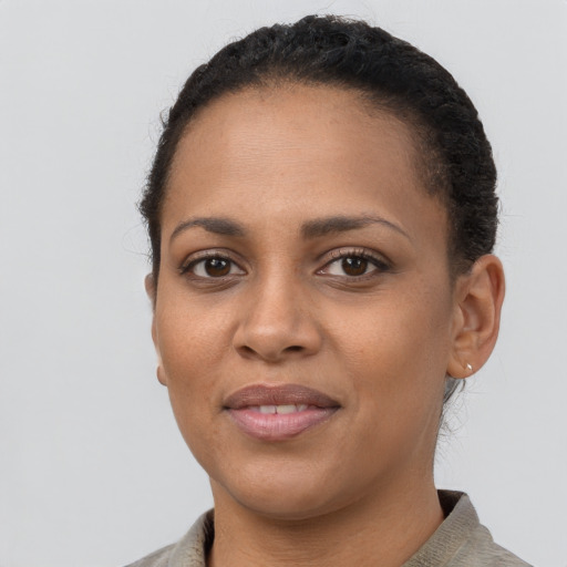 Joyful latino young-adult female with short  brown hair and brown eyes