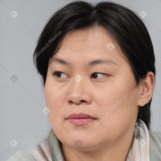 Joyful asian adult female with medium  brown hair and brown eyes