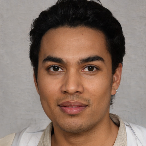 Joyful latino young-adult male with short  black hair and brown eyes