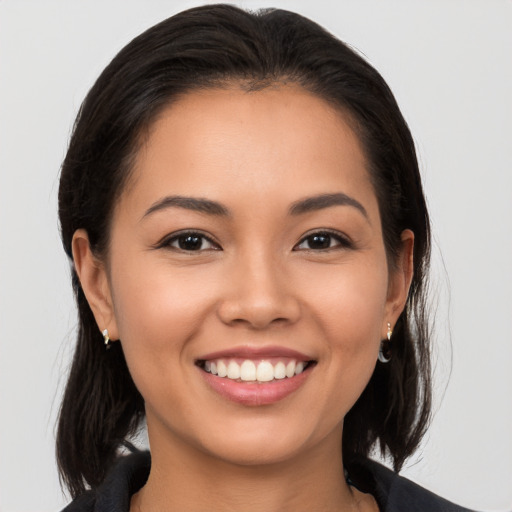 Joyful latino young-adult female with long  brown hair and brown eyes