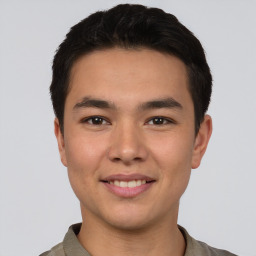 Joyful asian young-adult male with short  brown hair and brown eyes