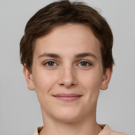 Joyful white young-adult female with short  brown hair and grey eyes