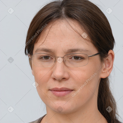 Joyful white adult female with long  brown hair and grey eyes