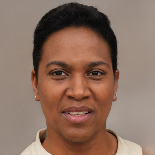 Joyful black young-adult female with short  black hair and brown eyes