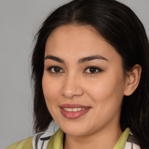 Joyful latino young-adult female with medium  brown hair and brown eyes