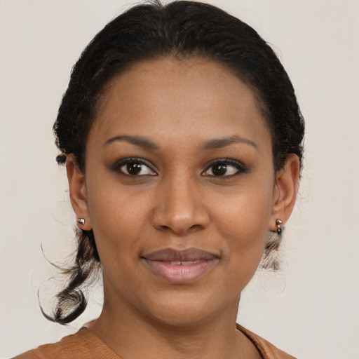 Joyful black young-adult female with medium  brown hair and brown eyes
