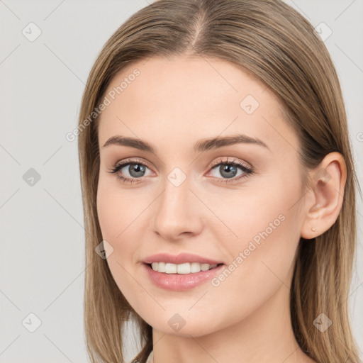 Joyful white young-adult female with long  brown hair and blue eyes