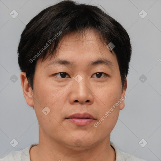 Neutral asian adult male with short  brown hair and brown eyes