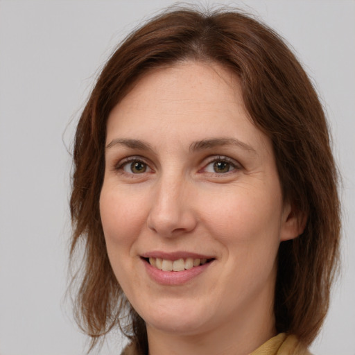 Joyful white adult female with medium  brown hair and brown eyes