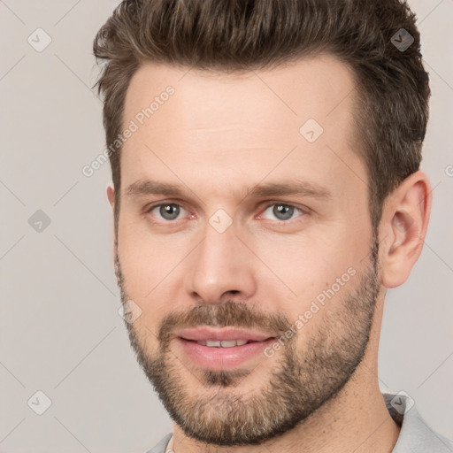 Joyful white young-adult male with short  brown hair and brown eyes