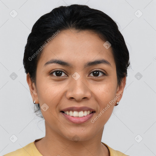 Joyful latino young-adult female with short  black hair and brown eyes