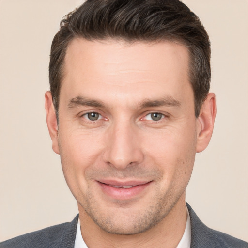 Joyful white young-adult male with short  brown hair and brown eyes