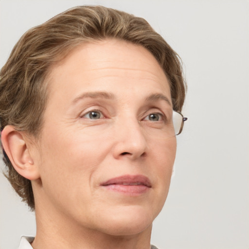 Joyful white adult female with short  brown hair and grey eyes