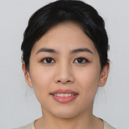 Joyful asian young-adult female with medium  black hair and brown eyes