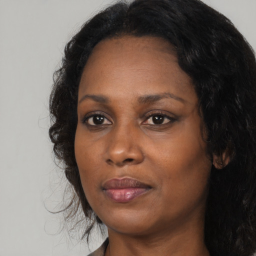 Neutral black adult female with long  black hair and brown eyes