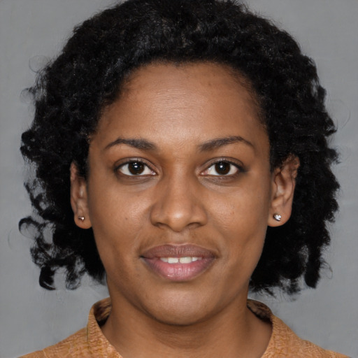 Joyful black young-adult female with medium  brown hair and brown eyes