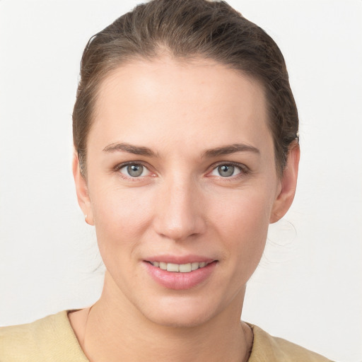 Joyful white young-adult female with short  brown hair and grey eyes