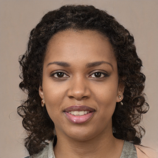 Joyful black young-adult female with medium  black hair and brown eyes