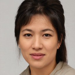 Joyful asian young-adult female with medium  brown hair and brown eyes