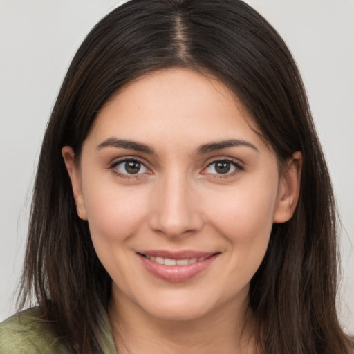 Joyful white young-adult female with long  brown hair and brown eyes