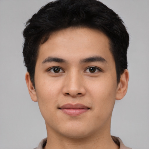 Joyful asian young-adult male with short  black hair and brown eyes