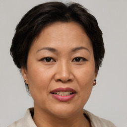 Joyful asian adult female with short  brown hair and brown eyes