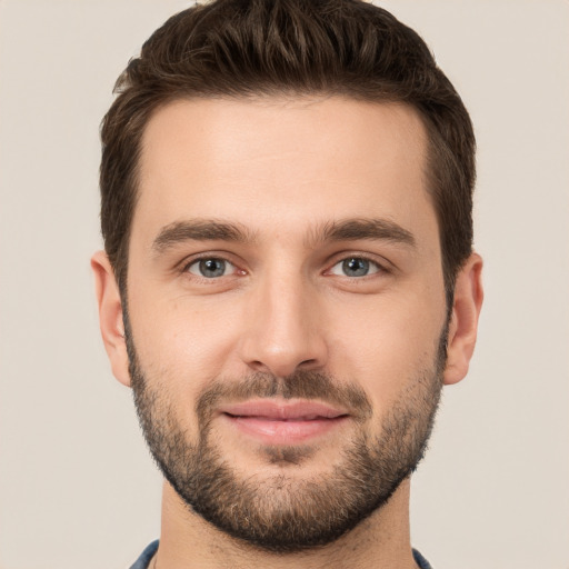 Joyful white young-adult male with short  brown hair and brown eyes