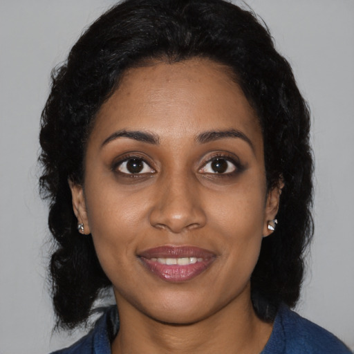 Joyful black young-adult female with medium  brown hair and brown eyes