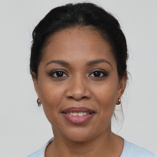 Joyful latino adult female with medium  brown hair and brown eyes