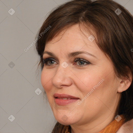 Joyful white adult female with medium  brown hair and brown eyes