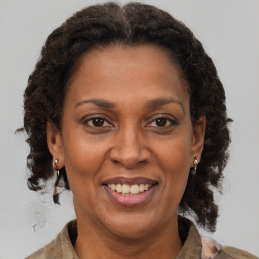 Joyful black adult female with medium  brown hair and brown eyes