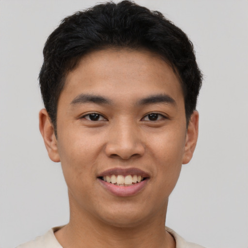 Joyful asian young-adult male with short  black hair and brown eyes