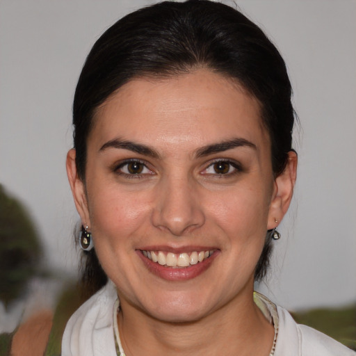 Joyful white young-adult female with medium  brown hair and brown eyes