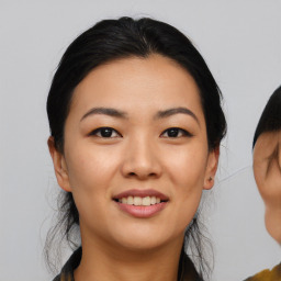 Joyful asian young-adult female with medium  black hair and brown eyes