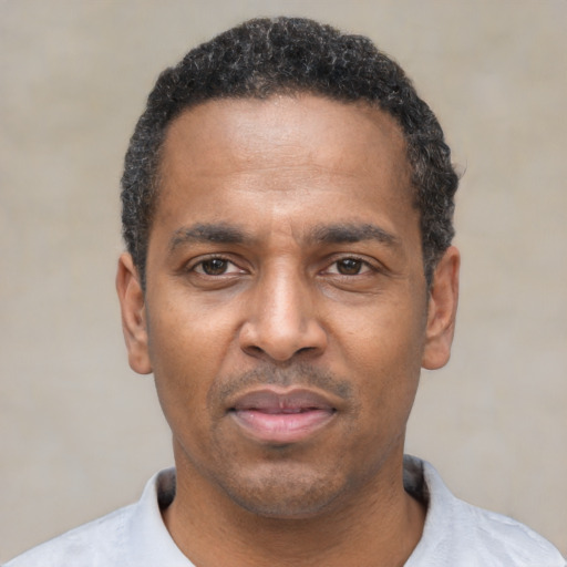 Neutral black adult male with short  black hair and brown eyes