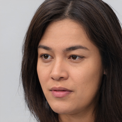 Joyful asian young-adult female with long  brown hair and brown eyes