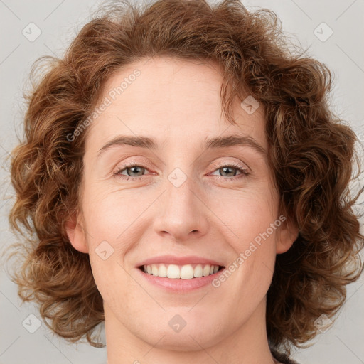 Joyful white young-adult female with medium  brown hair and blue eyes