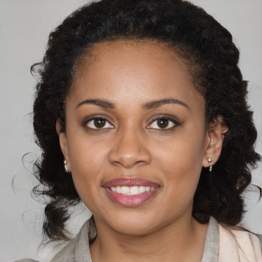 Joyful black young-adult female with medium  brown hair and brown eyes