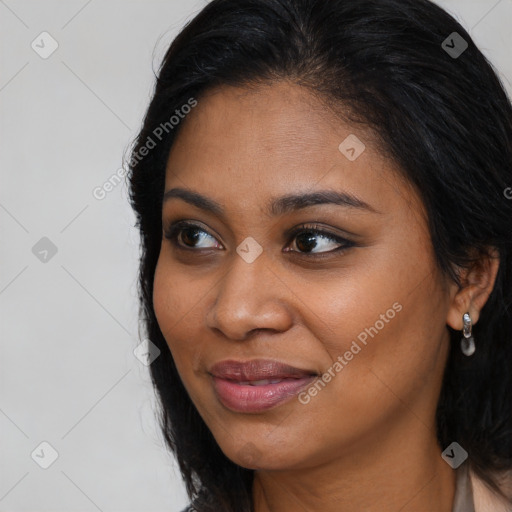 Joyful black young-adult female with long  brown hair and brown eyes