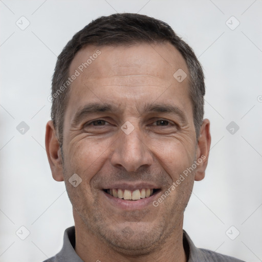 Joyful white adult male with short  brown hair and brown eyes