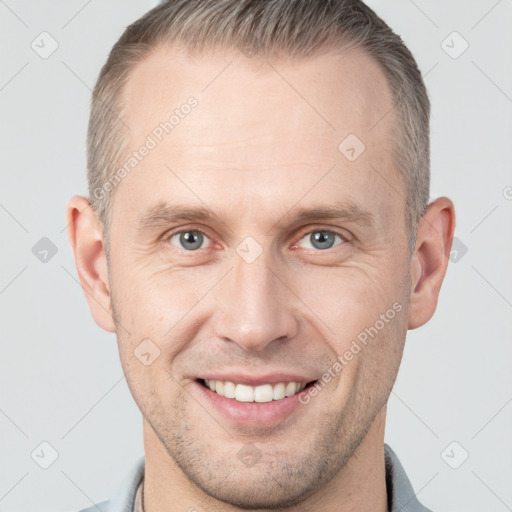 Joyful white adult male with short  brown hair and grey eyes