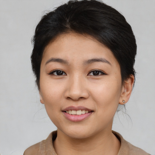Joyful asian young-adult female with medium  brown hair and brown eyes