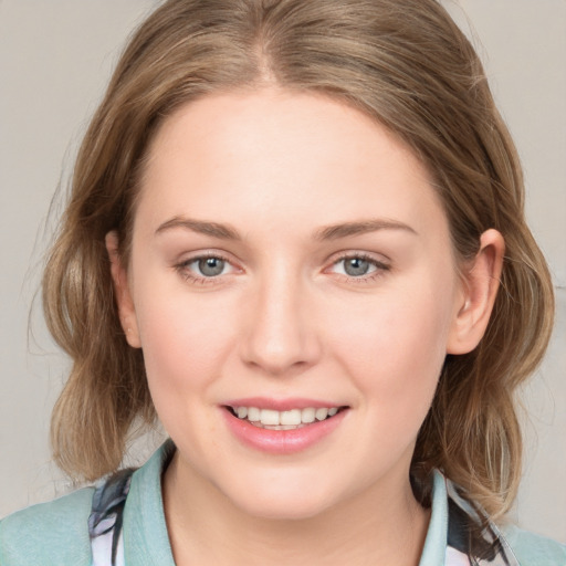 Joyful white young-adult female with medium  brown hair and blue eyes