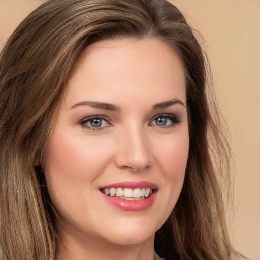 Joyful white young-adult female with long  brown hair and green eyes