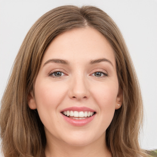 Joyful white young-adult female with long  brown hair and green eyes