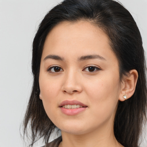 Joyful asian young-adult female with long  brown hair and brown eyes