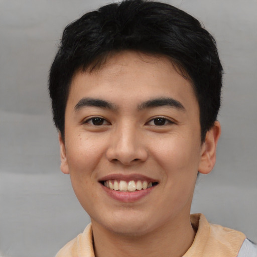 Joyful asian young-adult male with short  black hair and brown eyes
