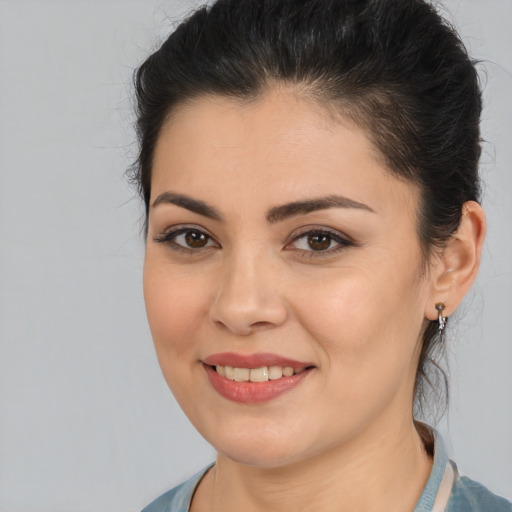 Joyful latino young-adult female with medium  brown hair and brown eyes