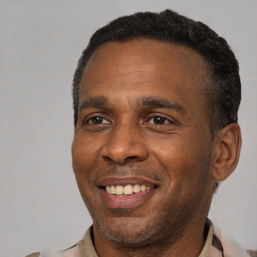 Joyful latino adult male with short  black hair and brown eyes