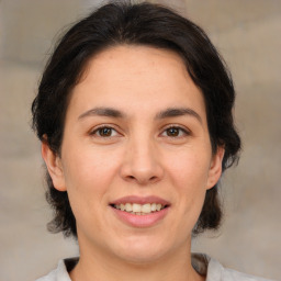 Joyful white adult female with medium  brown hair and brown eyes